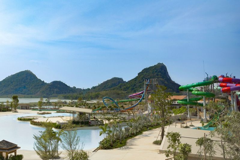 The Double Wave Pool at RamaYana WaterPark in Thailand is divided in half, with stormy waves on one side and gentle rocking waves on the other, all washing up along the "shore," a beach that spans 150 meters. Nestled between the two wave sections is the entertainment stage.