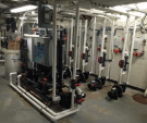 The NEX-GENpH® 80 is an on-site batch chlorine generator that uses salt (see feeder at left) instead of bulk chlorine to produce 80 lbs. of pH-neutral-equivalent chlorine per 24 hours. This unit was installed to feed five pools.