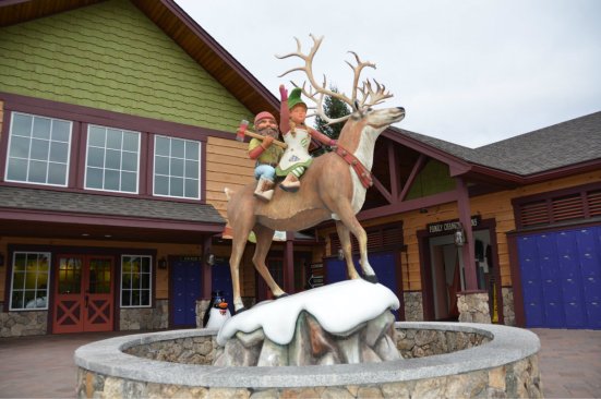 The storytelling doesn't end with the waterpark. Here, a couple of Santa's helpers sit atop their trusty reindeer in front of the village's Elfs Lodge. (A play on the Elks Lodge.) 